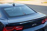 Chevrolet Camaro logo decal applied to the rear windscreen of a dark Camaro